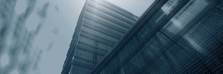 Glass exterior of a tall building viewed from the ground.