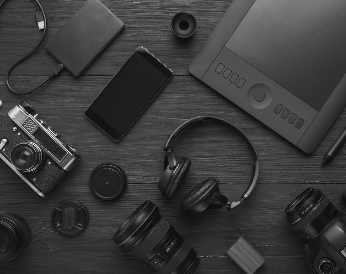 A variety of electronic equipment, such as headphones, cameras, and battery packs.