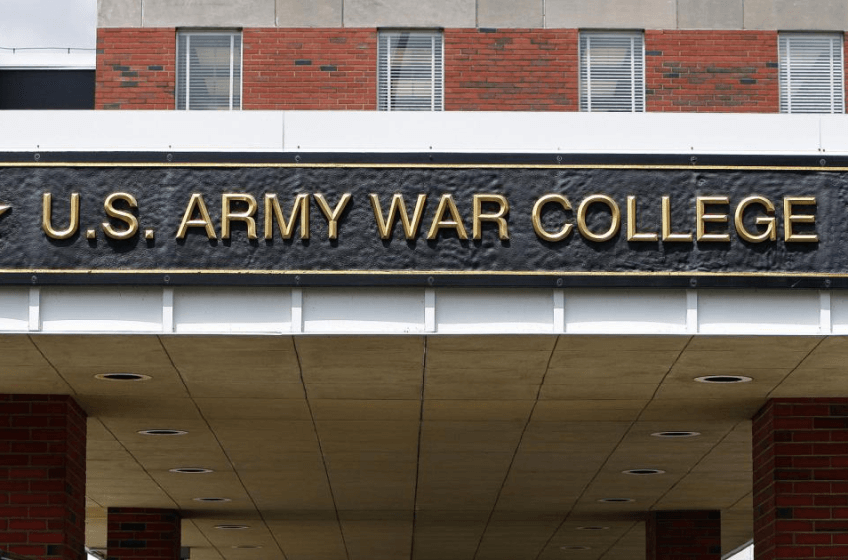 Facade of a brick building. Lettering over entrance reads 