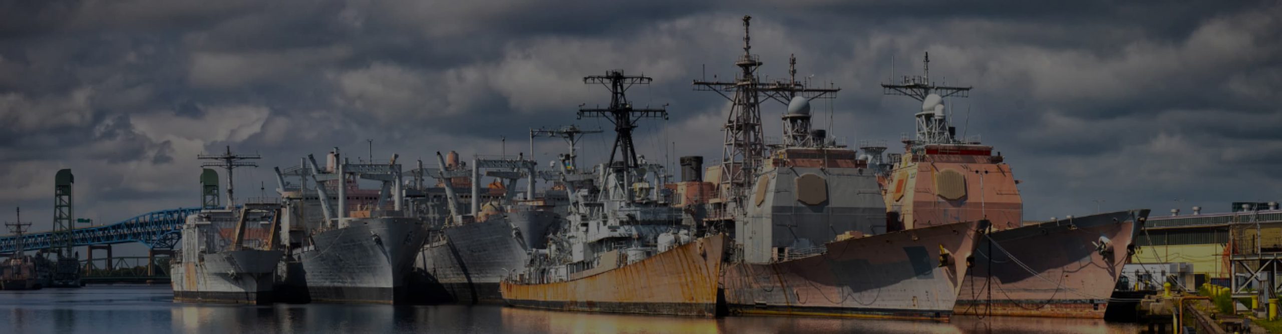 Decommissioned naval vessels, some with their hulls rusting.