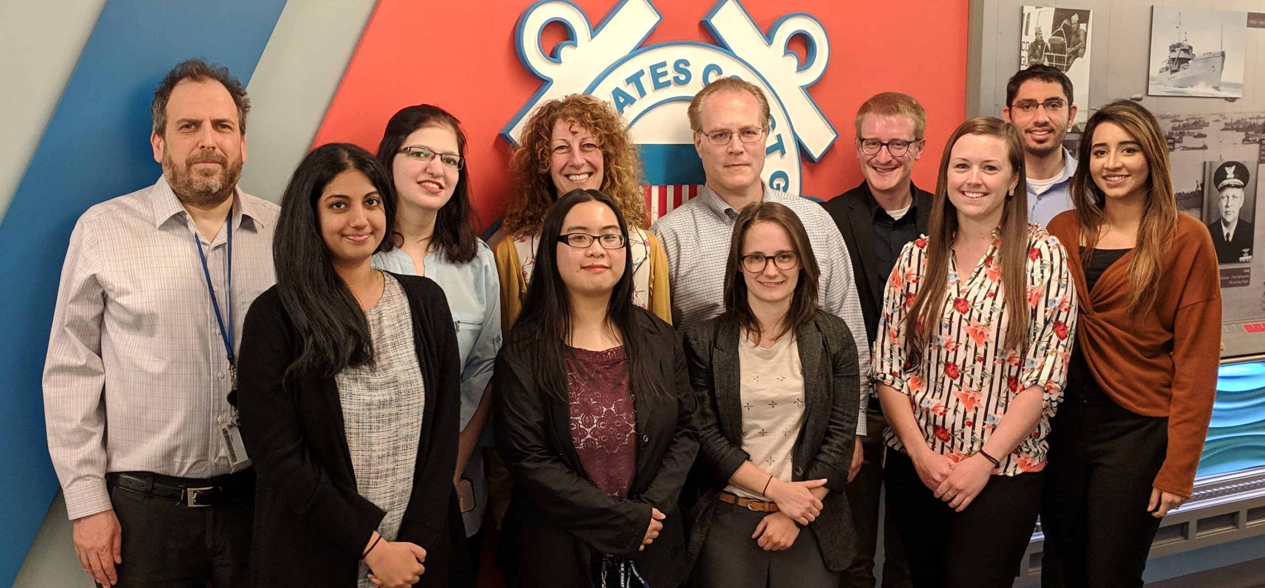 FedWriters team posing in front of the US Coast Guard emblem.