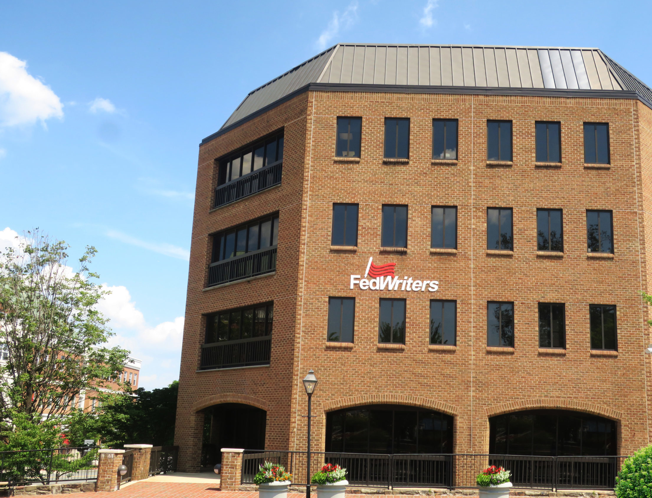 Picture of FedWriters' headquarters building with the FedWriters logo displayed on the side of the building.