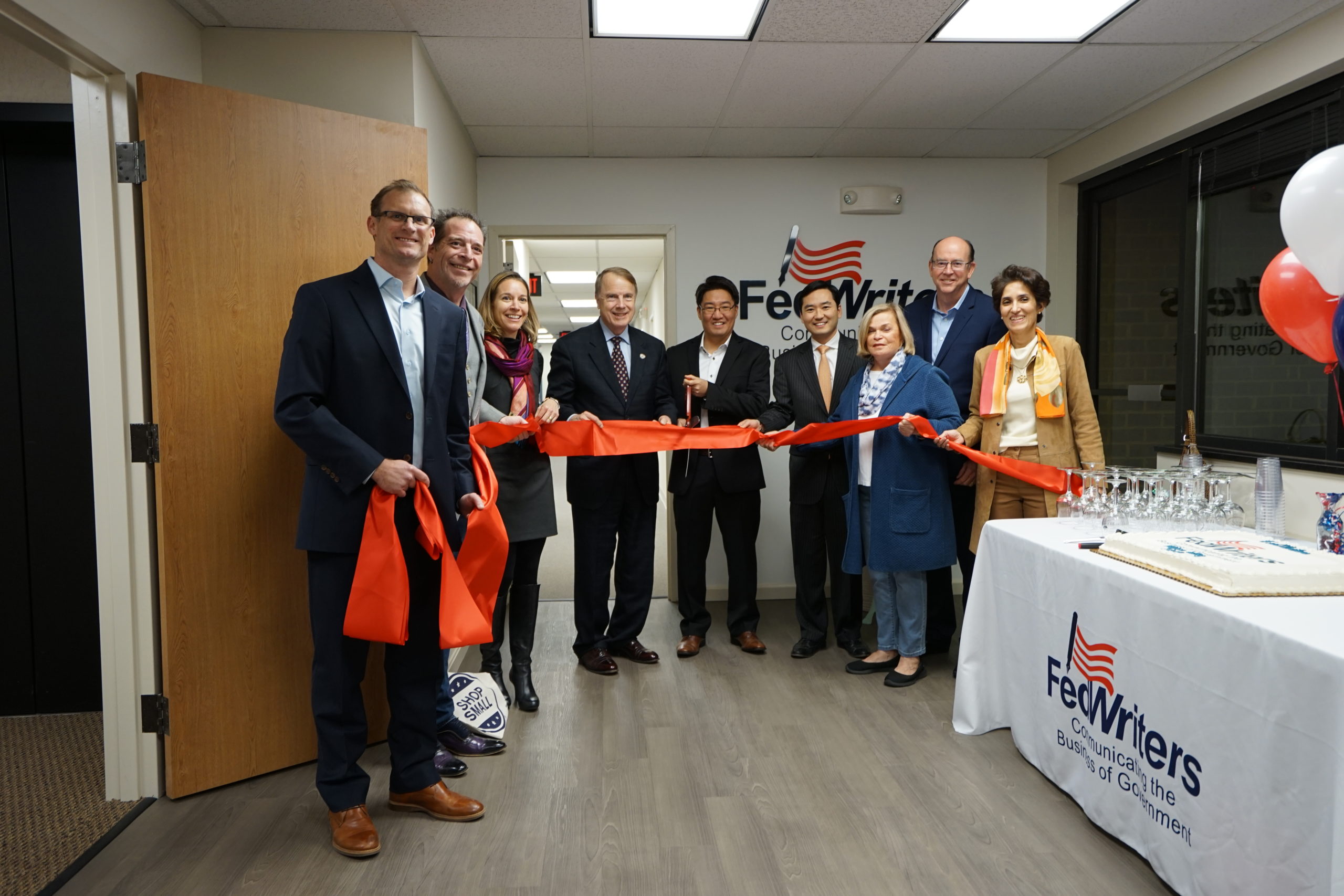 Ribbon cutting ceremony for FedWriters' headquarters, attended by FedWriters leadership and the Fairfax Economic Group.