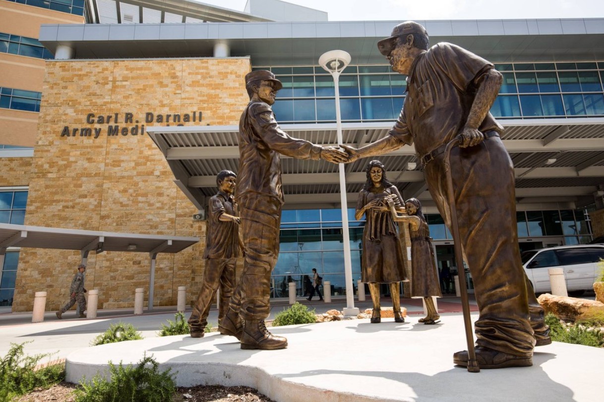 Bronze statues outside of the Carl R. Darnall Army Medical Center--a young soldier shakes hands with an older man.