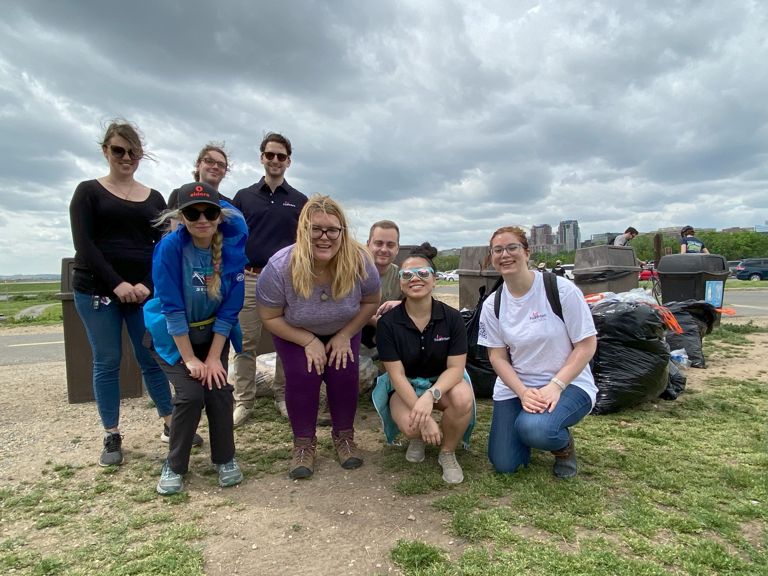 FedWriters employees posing together during an Earth Day activity.