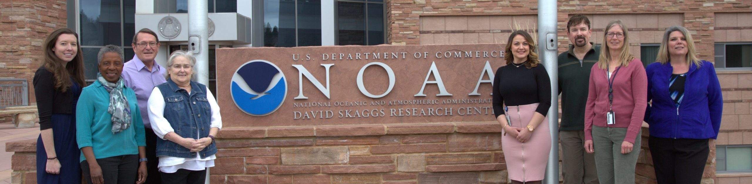 FedWriters team standing outside NOAA's (National Oceanic and Atmospheric Administration) David Skaggs Research Center in Boulder, Colorado
