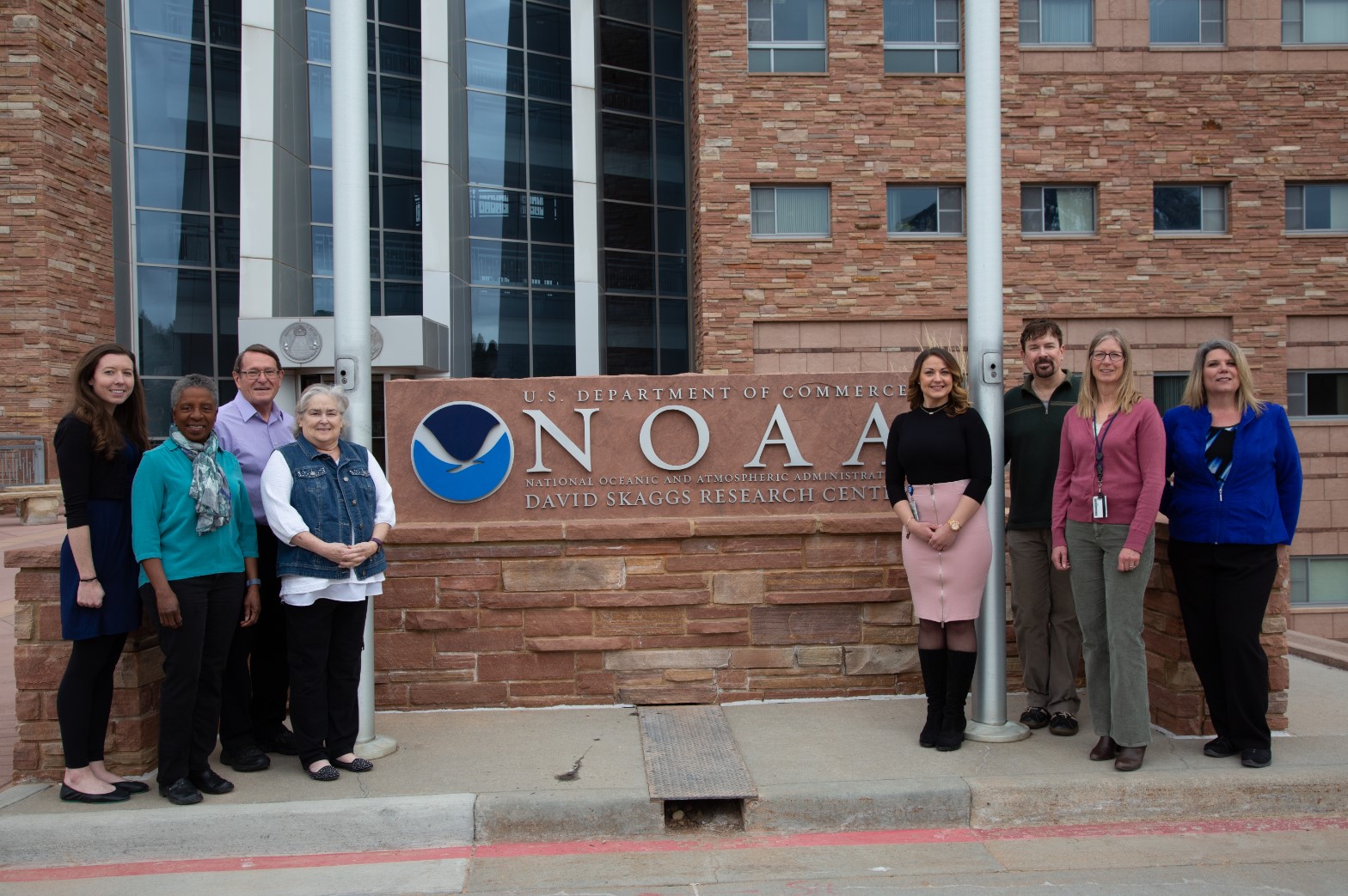 FedWriters team standing outside NOAA's (National Oceanic and Atmospheric Administration) David Skaggs Research Center in Boulder, Colorado.
