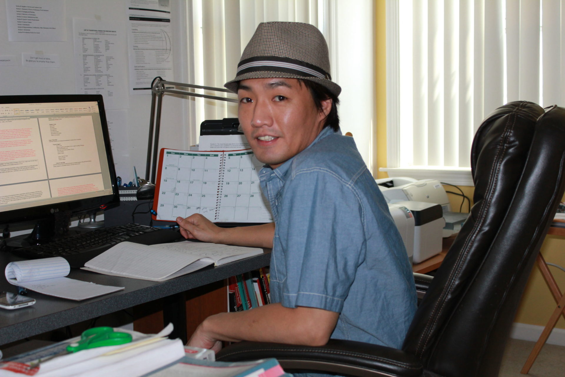 Founder and president Mitchell Cho seated at a computer desk in FedWriters' early days.