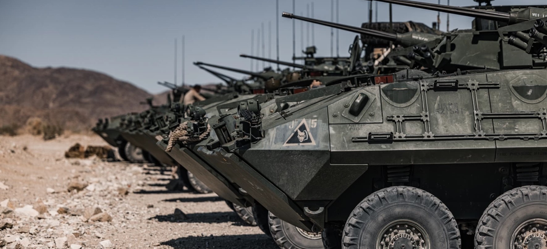 LAVs (light armored vehicles) lined up in a desert setting