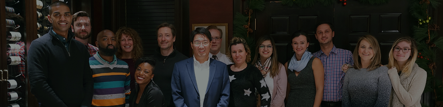 Mitchell Cho and FedWriters employees pose together at a restaurant.